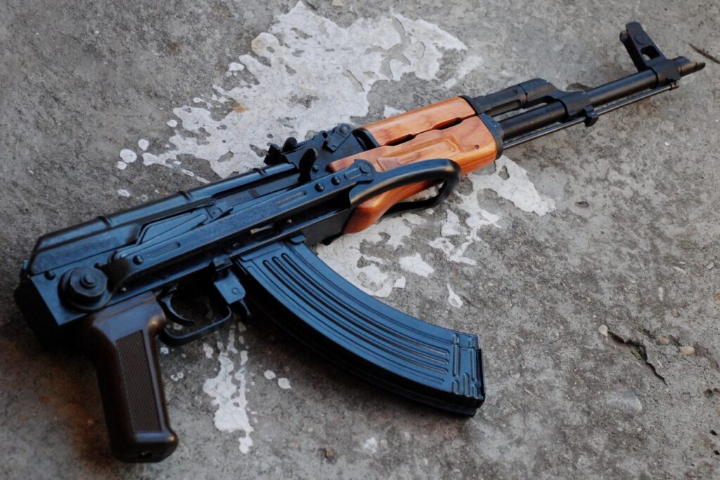 AK-47 rifle with wooden stock and 7.62x39mm magazine, ideal for home defense, range shooting, and survival use